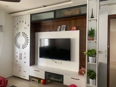 a flat screen tv sitting on top of a white entertainment center