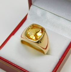 Gemstone: Golden Citrine Treatments: None Measures: 12x10mm Weight: 3.72 carats Clarity: Eye clean Cut: Rectangle cushion cut Metal: Shown in 18K yellow gold Weight: Approx. 20 -22 grams Ring size: This ring is available in all sizes from a low of 5 to a high of 12 This is as fine and elegant a man's ring as you will ever find. The perfect blend of a fine gemstone matched up with a clean classic 18K yellow gold ring. Good solid weight, nicely distributed to give the ring an even weight so that i Yellow Stone Ring Men, Gold Ring With Stone For Man, Yellow Sapphire Ring Men Gold, Yellow Sapphire Ring Men Design, Men Gemstone Ring Design, Classic Yellow Signet Ring With Polished Finish, Yellow Signet Ring With Polished Finish For Formal Occasions, Classic Gold Citrine Signet Ring, Classic Yellow Hallmarked Signet Ring