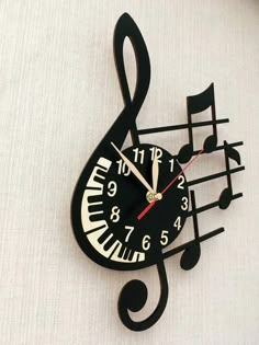 a black clock with musical notes on it