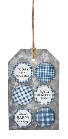 four blue and white plaid tags hanging from a string