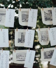 several pictures hanging from clothes pins with names on them