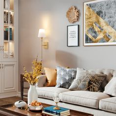 a living room filled with lots of furniture next to a wall mounted book shelf and lamp