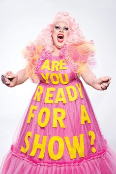 a woman in pink and yellow dress with words on her body that read are you ready for a show?