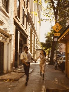 a man and woman walking down a city street