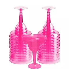 three pink vases and one glass are sitting next to each other on a white background