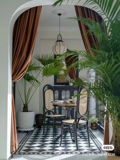 an outdoor dining area with black and white checkered tile flooring, potted plants and hanging lights