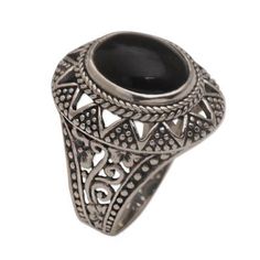 Centered by an oval of dark onyx this Balinese cocktail ring features an original design by Made Sugi. The ring is crafted of sterling silver featuring openwork floral motifs at the band with dotted triangle motifs around the crown. Ornate Black Oval Ring, Black Oval Ring With Intricate Design, Black Oval Rings With Intricate Design, Black Oval Filigree Ring, Silver Oval Ring, Rings Sterling Silver, Silver Cocktail, Oval Ring, Ring Oval