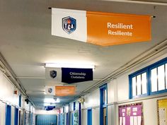 an empty hallway with banners hanging from the ceiling