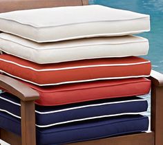 four pillows stacked on top of each other next to a pool