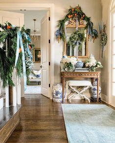 an entryway decorated for christmas with wreaths and greenery