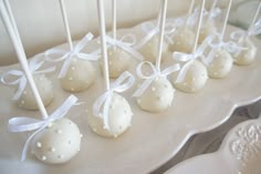 some white cake pops are on a plate