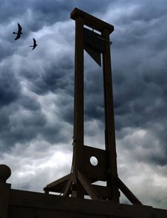 a clock tower with birds flying in the sky above it and an ad for facebook