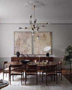 a dining room table with six chairs and a large painting on the wall behind it