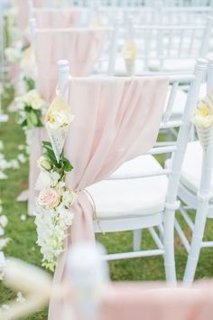 rows of white chairs with pink sashes and flowers