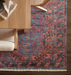 a table with a chair and rug on top of it next to a computer mouse