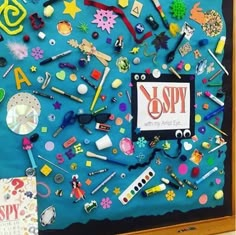 a bulletin board covered in school supplies and magnets