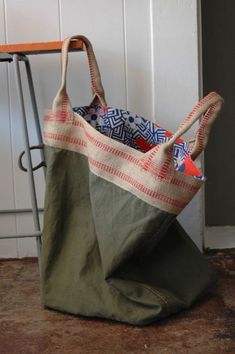 a bag sitting on the ground next to a chair