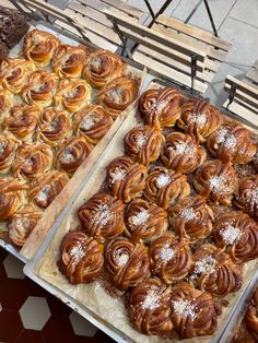 two trays filled with pastries sitting next to each other on top of a table