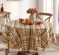 a plaid table cloth with pumpkins on it