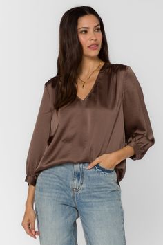 Get ready to feel elegant and chic with our Robyn Satin Blouse. Made from luxurious satin, this blouse pairs perfectly with our Carnaby Trousers for an effortless day-to-play look. So go ahead, treat yourself to a touch of sophistication. (You deserve it!) Stunning, brown satin V-neck front Slouchy fit 3/4 sleeves The material is polyester. The blouse runs true to size. The model is 5'9" and is wearing a size small. Care instructions: dry clean only Everyday Pants, Brown Satin, Denim Outerwear, You Deserve It, Sweater Tank Top, Satin Blouse, Satin Top, Dress Trousers, New Tops