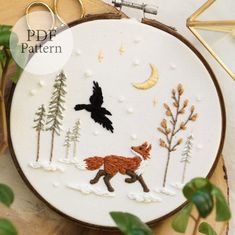 an embroidery pattern with a fox and a bird in the woods