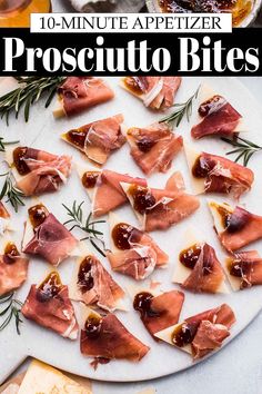 prosciutto bites are arranged on a platter with rosemary sprigs