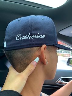 a person wearing a blue hat with the word catheine on it's side