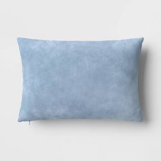 a blue pillow on a white wall