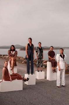 a group of people sitting on top of white blocks