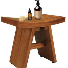 a wooden table with soap and lotion on it, next to a bottle of shampoo