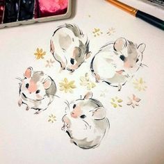 three little hamsters are sitting on the table next to some watercolors and crayons