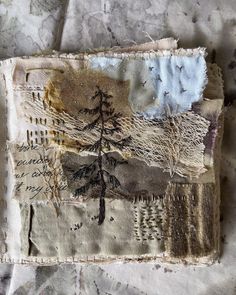 a piece of fabric with trees on it and some writing on the side of it