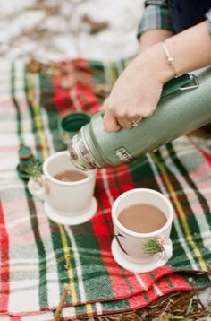 two cups of coffee on a table with the words happy thursday