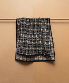 a black and white checkered cloth hanging on a wall