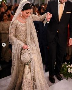 the bride and groom are walking down the aisle