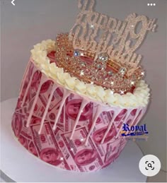 a birthday cake decorated with money and a tiara