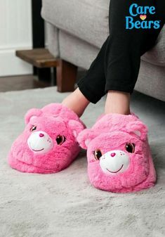 The Care Bears make everything cozy, don't they? Just one look at Cheer Bear and her joyous face can warm your heart when you're feeling down (that's sort of her thing). But now, the fuzzy pink bear can help you keep your toes warm too! That's right, these Cheer Bear Slippers will have your feet feeling terrific with just a little bit of help from the most optimistic bear in all of Care-A-Lot. These slippers will keep your feet cozy with a layer of plush material on the exterior. Of course, it'l Care Bears Cheer Bear, Kids Cheering, Slippers For Kids, Cheer Bear, Bear Slippers, Faux Fur Material, Dream Fashion, Bear Nursery, Cute Slippers