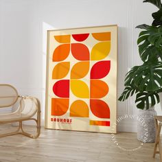 an orange, yellow and red abstract art print on a white wall next to a chair