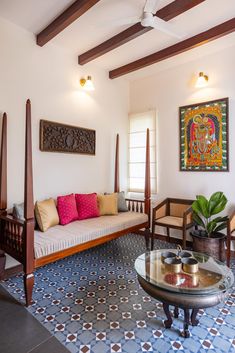 a living room filled with furniture and a painting on the wall next to a window