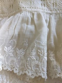 Here is such a pretty pair of women's underwear from the late Victorian or Edwardian era.  The fancy bloomers or pantaloons features wide embroidery trim in a whitework at the hem.   The eyelet scallop edging features a leaf-flower in a scroll design, which is 5" wide.  Sewn just above this pretty embellishment is eyelet lacing for inserting a ribbon.   The width of this edging is 1-1/2" wide.   How dramatic this would be with a soft color ribbon tied with bows.  Wouldn't it be fabulous hung in a bedroom for a truly feminine decor?  Other features is a button back waistband and wide legs.  If you look at the construction of the garment you will find it nicely made.  Probably the only flaw is the bloomers need to be laundered.  Some oxidation from storage on one of the legs.  With a good so Victorian Bloomers, Womens Bloomers, Feminine Decor, Leaf Flower, Scroll Design, Edwardian Era, Lovely Clothes, Eyelet Lace, White Embroidery