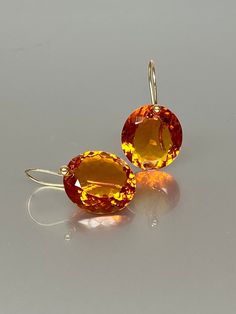 Gorgeous Madeira Citrine drops earrings. The oval  Madeira Citrine drops are eye clean, flawless, and have a beautiful rich golden whiskey color. The drops are attached to 24k gold vermeil /14K SOLID GOLD ear wires. The earrings are elegant, have a lux look, and make a statement.  A truly gorgeous pair of earrings. When 14K SOLID GOLD ear wires are being used, the ear wire ends are hand-stamped as proof of being 14K solid gold. In addition, extra work was done at the end of the ear wires to prev Luxury Citrine Earrings, Luxury Orange Drop Earrings, Formal Round Citrine Earrings, Yellow Gold Topaz Earrings, Round Shape, Orange Gemstone Drop Jewelry, Orange Gemstone Drop Earrings, Orange Drop Gemstone Jewelry, Orange Teardrop Gemstone Earrings, Orange Citrine Gemstone Earrings