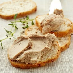 two pieces of bread with peanut butter on top and sprig of green leaves