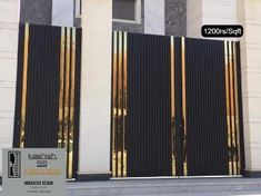 a black and gold gate on the side of a building