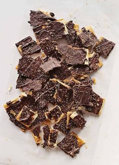 a pile of brownies sitting on top of a white counter next to a knife