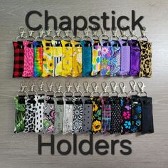 a bunch of different types of key chains hanging on a wall with the words, chapstick holders