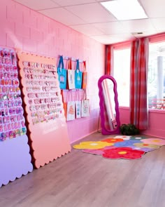 a room that has pink walls and colorful rugs on the floor in front of it