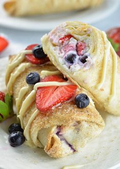 a blue plate topped with slices of cake and berries