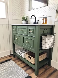 a green bathroom vanity with two baskets under it