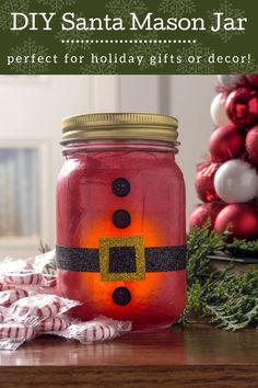 a mason jar with santa's face on it sitting next to christmas decorations and ornaments