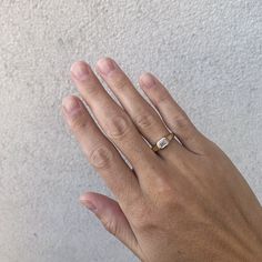 a person's hand with two rings on it